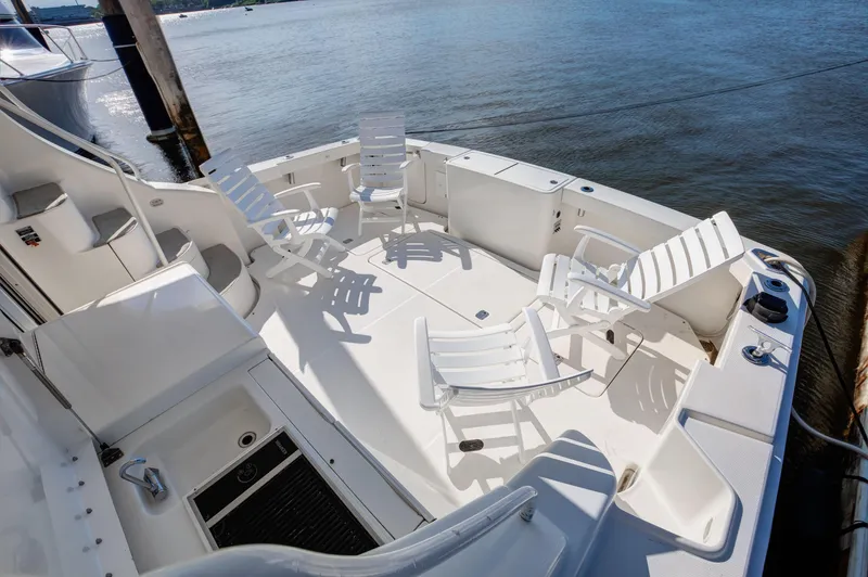  Yacht Photos Pics 2006 Silverton 50 Convertible yacht deck with white chairs by the water.
