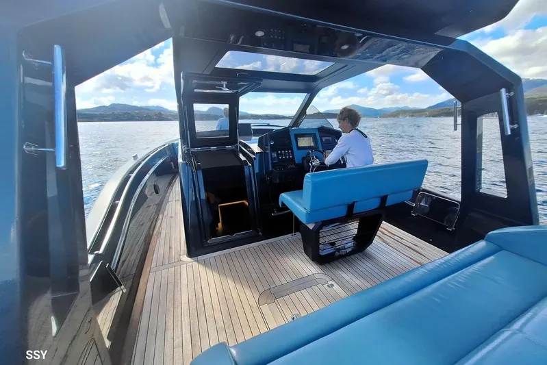 African Yacht Photos Pics 2017 Maori 50 T-Top boat interior with captain navigating on open water.