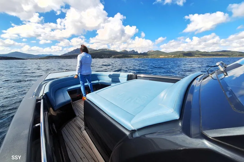 African Yacht Photos Pics Person standing on a 2017 Maori 50 T-Top yacht, enjoying scenic ocean view.