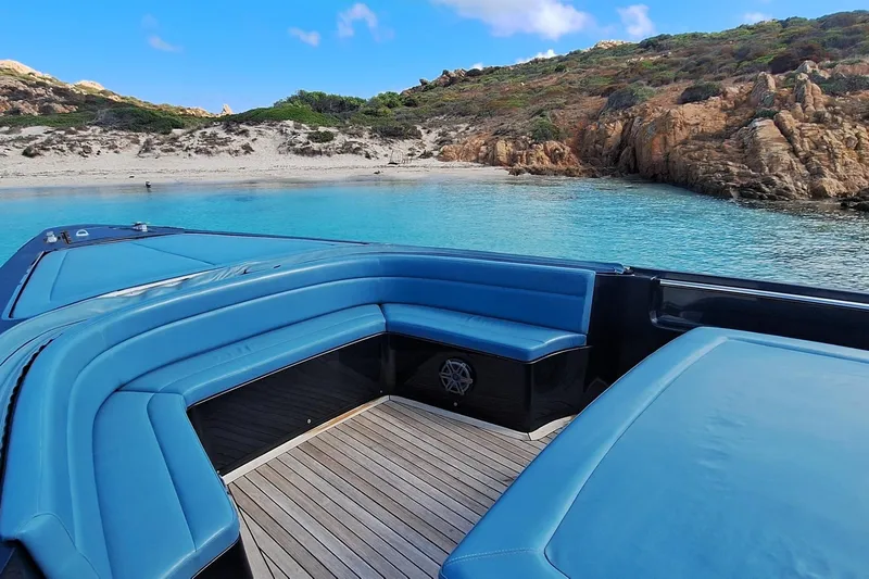 African Yacht Photos Pics 2017 Maori 50 T-Top yacht with blue seating, near rocky coastline and clear water.