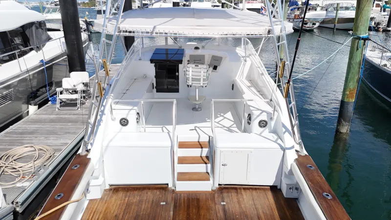  Yacht Photos Pics 1997 Strike 42 boat docked at marina, featuring spacious deck and seating area.