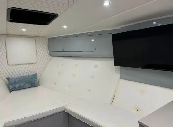  Yacht Photos Pics Luxurious interior of a 1997 Strike 42 yacht with modern seating and a flat-screen TV.