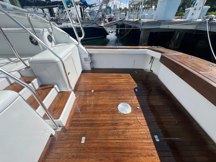  Yacht Photos Pics Spacious deck of 1997 Strike 42 boat with wooden flooring and dock view.