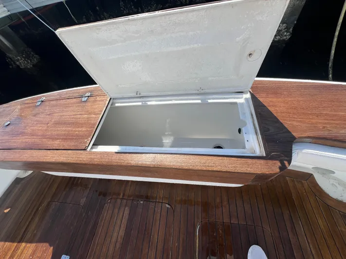  Yacht Photos Pics Open storage compartment on 1997 Strike 42 boat with wooden deck.
