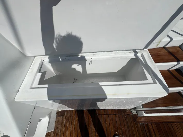  Yacht Photos Pics Shadow of a person on a boat deck near a white compartment, Strike 42, 1997 model.