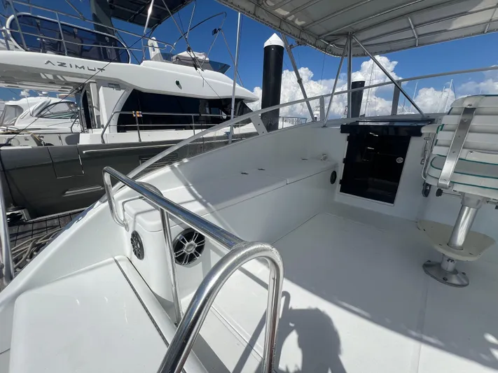  Yacht Photos Pics 1997 Strike 42 boat deck with seating, railing, and clear sky background.