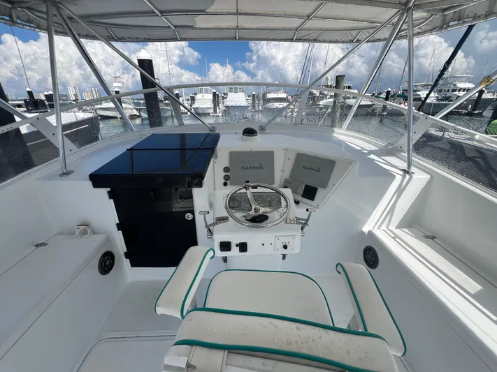  Yacht Photos Pics Helm of 1997 Strike 42 boat with steering wheel and navigation equipment.