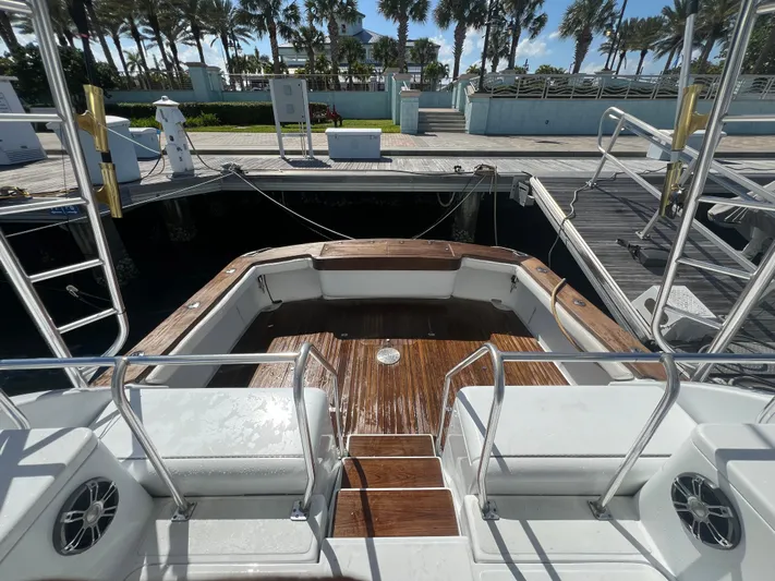  Yacht Photos Pics Back view of a 1997 Strike 42 boat docked, featuring a wooden deck and metal railings.