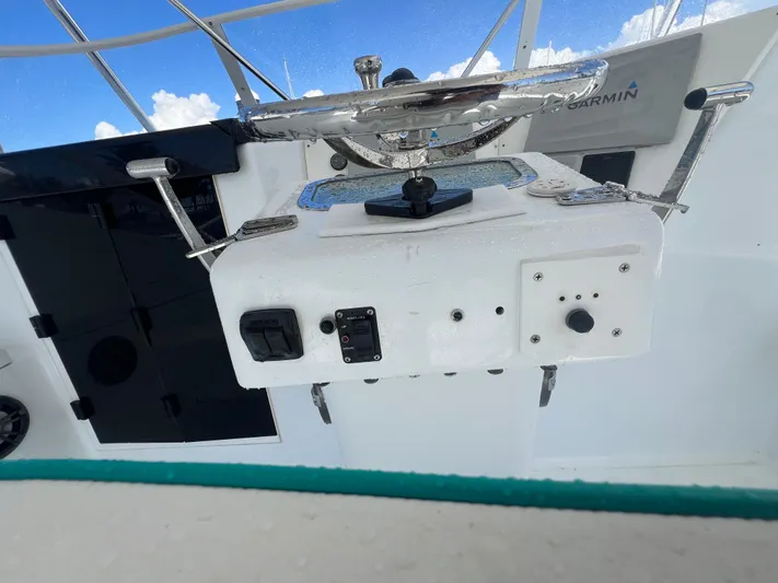  Yacht Photos Pics Control panel of a 1997 Strike 42 boat with steering wheel and instruments.