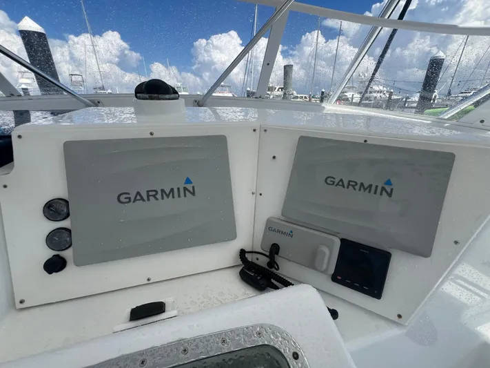  Yacht Photos Pics Control panel of a 1997 Strike 42 boat featuring Garmin navigation systems.