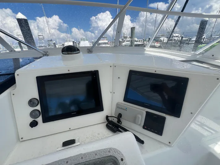  Yacht Photos Pics Control panel of a 1997 Strike 42 boat with navigation screens and gauges.