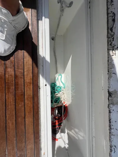  Yacht Photos Pics Boat deck storage with ropes, wooden flooring, and a sneaker. Strike 42, 1997 model.