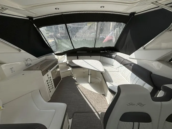  Yacht Photos Pics Interior of 2016 Sea Ray 350 SLX boat with seating and table.