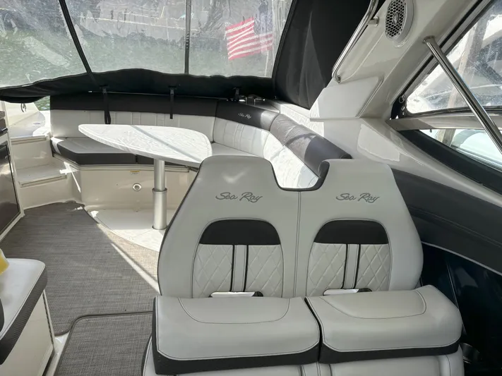  Yacht Photos Pics Interior of 2016 Sea Ray 350 SLX boat with seating and table.