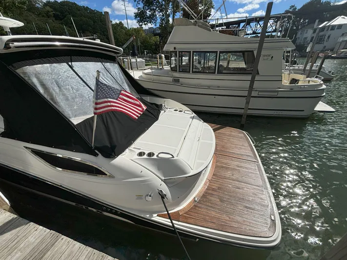  Yacht Photos Pics 2016 Sea Ray 350 SLX docked with American flag, sunny marina setting.