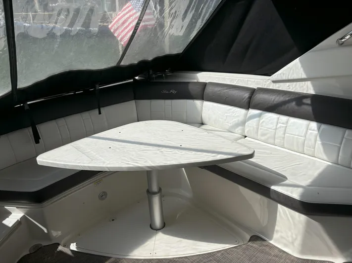  Yacht Photos Pics Interior seating area of 2016 Sea Ray 350 SLX boat with table.