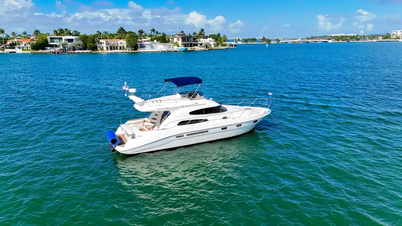 Seafari Yacht Photos Pics 2004 Sealine 47 yacht cruising on clear blue waters under a sunny sky.