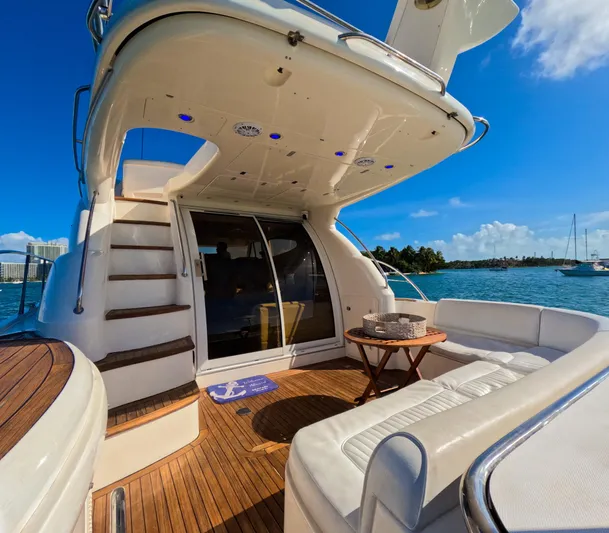 Seafari Yacht Photos Pics Luxury 2004 Sealine 47 yacht deck with seating, table, and ocean view.