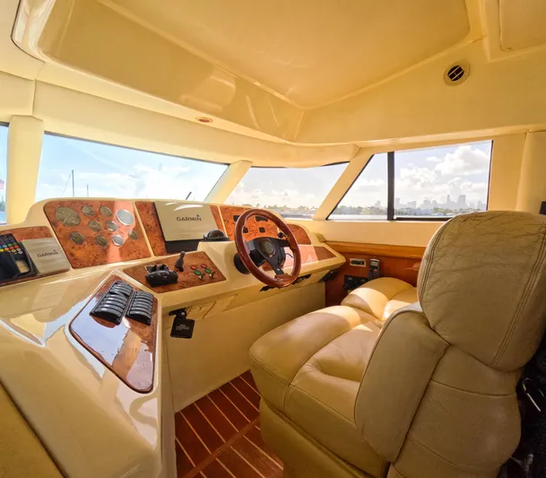 Seafari Yacht Photos Pics Luxurious 2004 Sealine 47 yacht interior with leather seating and modern dashboard controls.