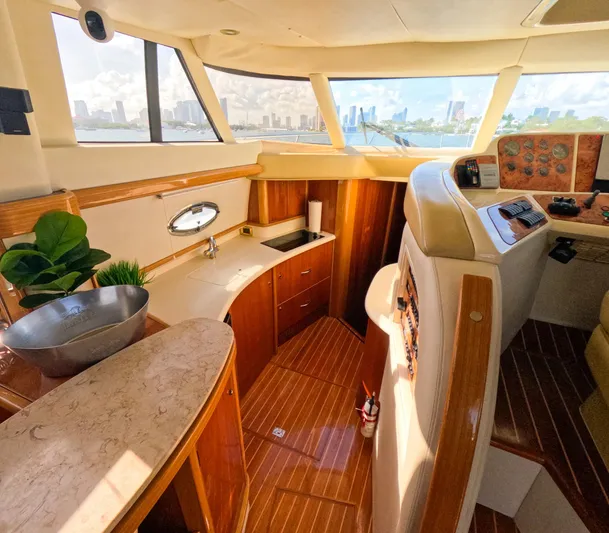 Seafari Yacht Photos Pics Luxurious 2004 Sealine 47 yacht interior with wood finish and panoramic windows.