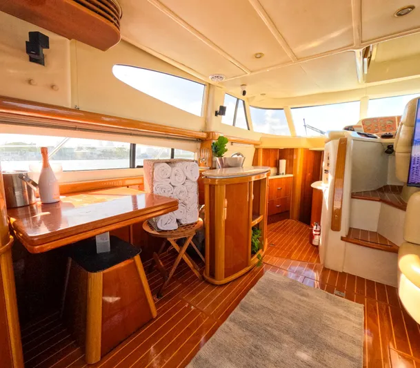 Seafari Yacht Photos Pics Luxurious interior of 2004 Sealine 47 yacht with wooden furnishings and ample natural light.