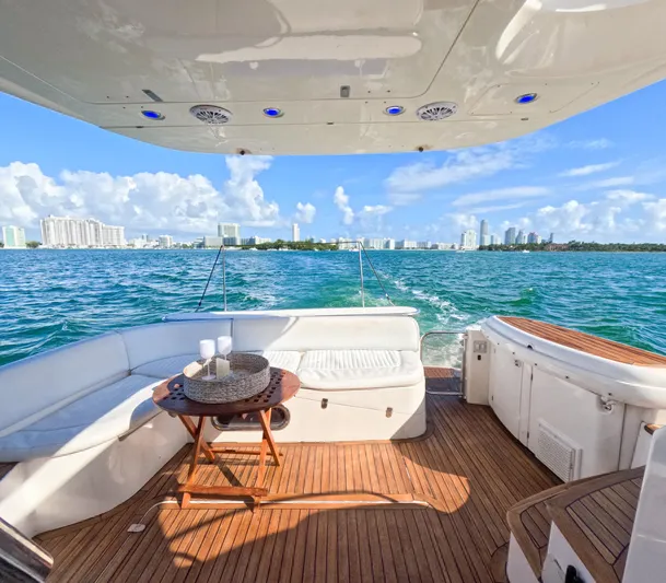 Seafari Yacht Photos Pics Luxury Sealine 47 yacht deck with ocean view, featuring comfortable seating and table, 2004 model.