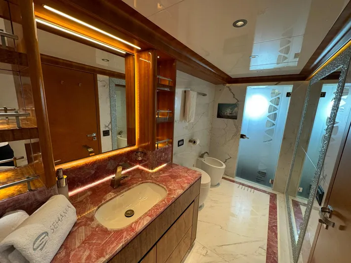 Sehamia Yacht Photos Pics Luxurious bathroom on 2018 Gulf Craft Majesty 155 yacht with marble accents and modern fixtures.