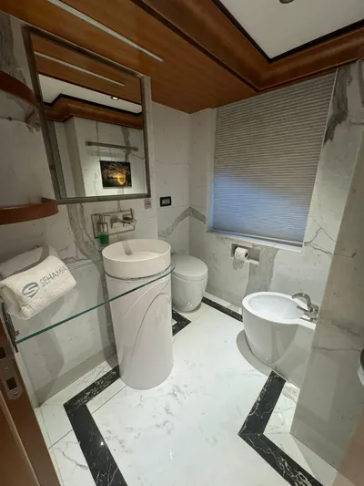 Sehamia Yacht Photos Pics Luxurious bathroom on 2018 Gulf Craft Majesty 155 yacht with modern fixtures and elegant marble design.