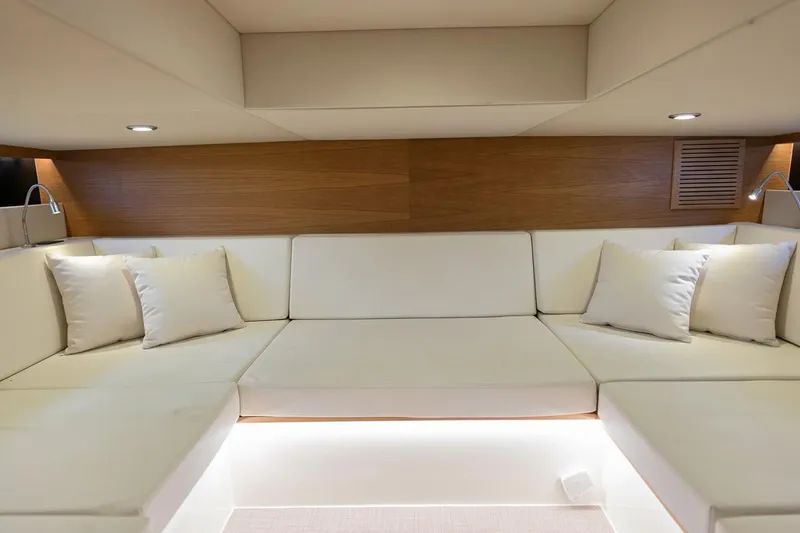 Never Enough Yacht Photos Pics Luxurious interior of 2023 De Antonio Yachts D42 Open with plush seating and ambient lighting.