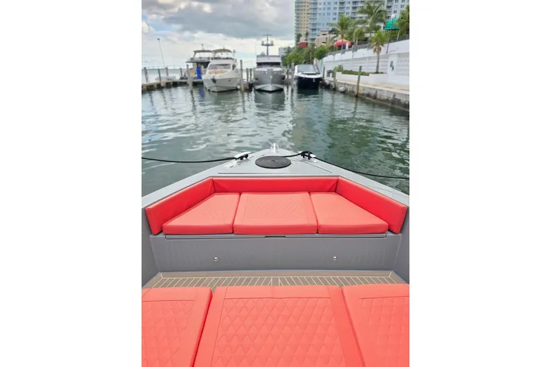 Never Enough Yacht Photos Pics 2023 De Antonio Yachts D42 Open with red seating, docked in a marina.