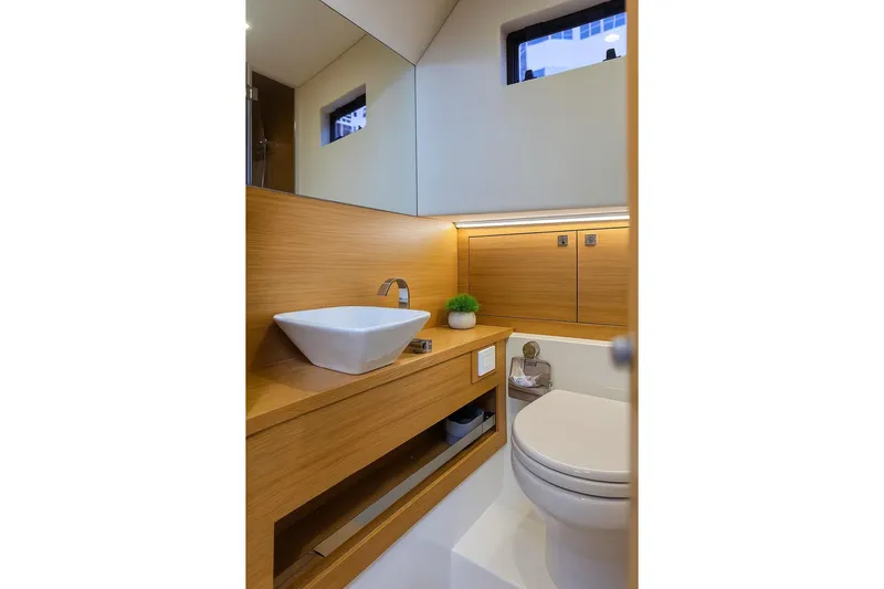 Never Enough Yacht Photos Pics Luxurious bathroom in 2023 De Antonio Yachts D42 Open, featuring modern sink and toilet.