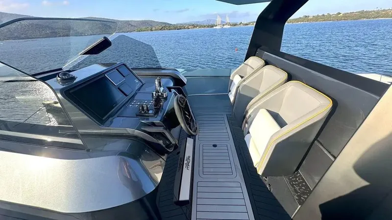  Yacht Photos Pics 2024 Maori 46ft yacht cockpit with modern controls and seating, overlooking serene water and distant hills.