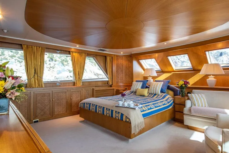  Yacht Photos Pics Luxurious 1982 Feadship Classic yacht bedroom with elegant wood paneling and large windows.