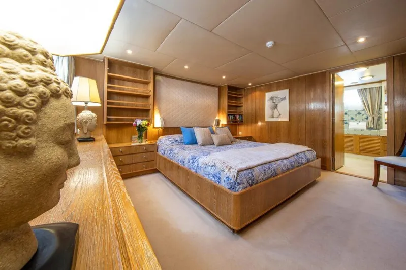  Yacht Photos Pics Luxurious bedroom interior on 1982 Feadship Classic yacht, featuring elegant wood paneling and decor.
