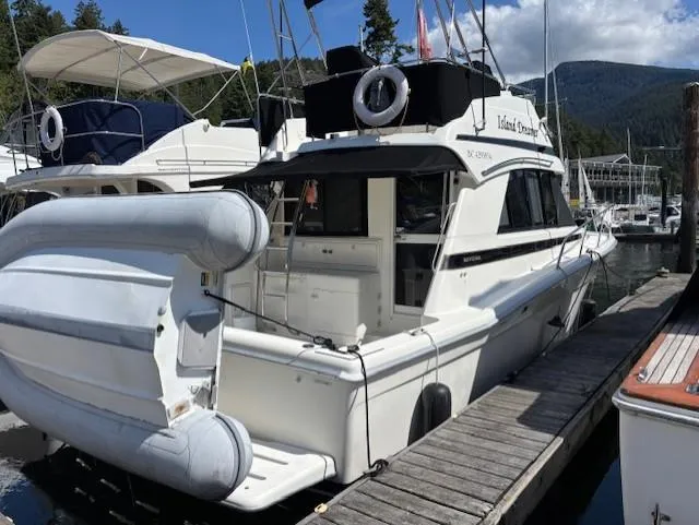 Island Dreamer Yacht Photos Pics 1999 Riviera Convertible yacht docked at marina with inflatable boat attached.