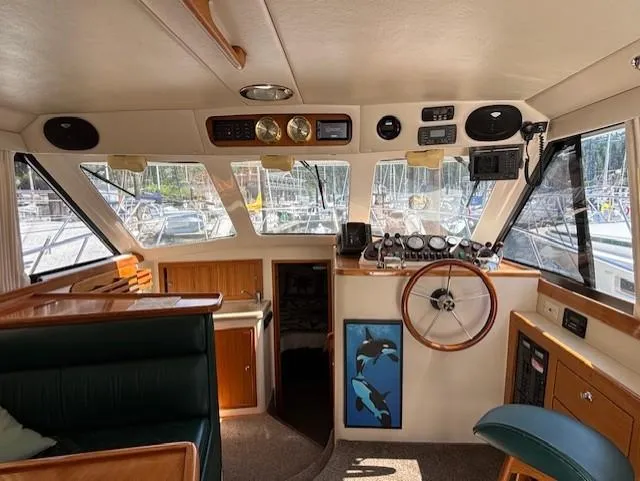 Island Dreamer Yacht Photos Pics Interior of a 1999 Riviera Convertible boat with steering wheel and navigation instruments.