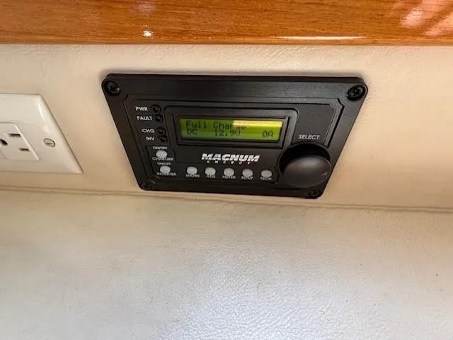 Island Dreamer Yacht Photos Pics Control panel in a 1999 Riviera Convertible boat, displaying battery charge status.