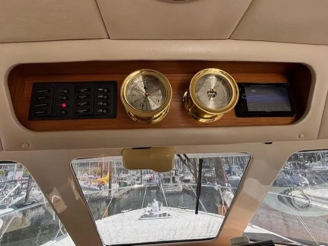 Island Dreamer Yacht Photos Pics 1999 Riviera Convertible dashboard with gauges and control panel, overlooking marina.