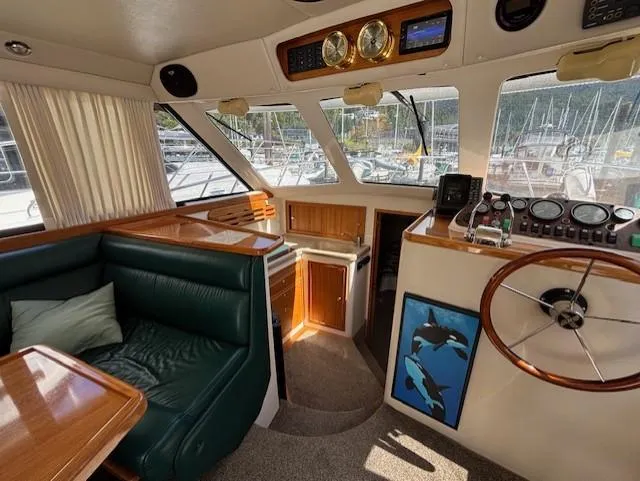 Island Dreamer Yacht Photos Pics Interior of a 1999 Riviera Convertible yacht with green seating and wooden accents.
