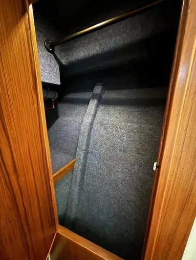 Island Dreamer Yacht Photos Pics 1999 Riviera Convertible interior closet with wooden finish and carpeted walls.