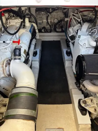 Island Dreamer Yacht Photos Pics Engine compartment of a 1999 Riviera Convertible boat, showcasing dual engines and mechanical components.