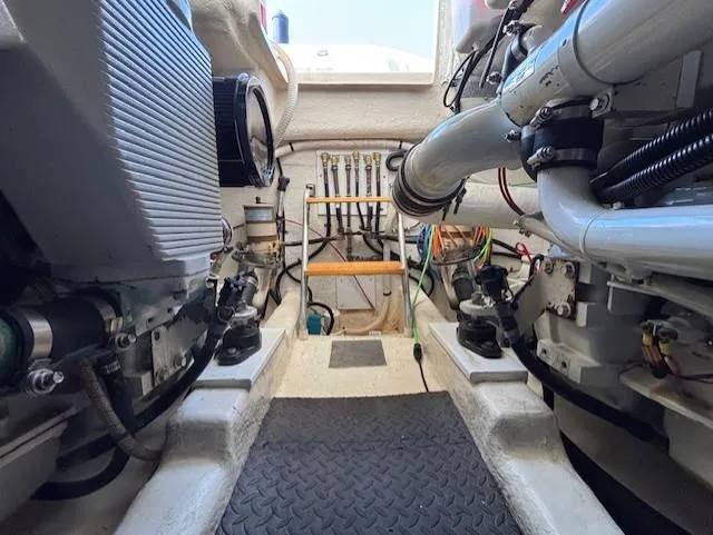Island Dreamer Yacht Photos Pics Engine room of a 1999 Riviera Convertible boat, showcasing mechanical components and piping.