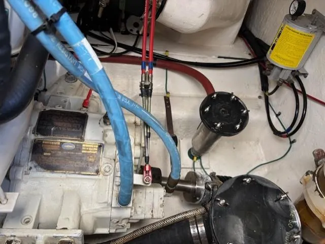 Island Dreamer Yacht Photos Pics Engine compartment of a 1999 Riviera Convertible with visible hoses and mechanical components.