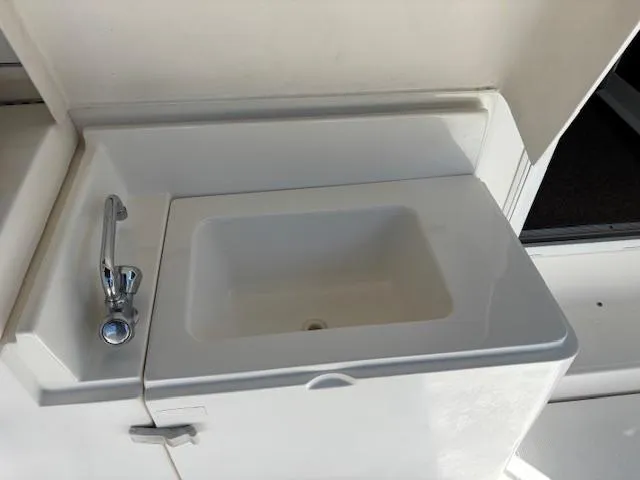 Island Dreamer Yacht Photos Pics 1999 Riviera Convertible boat sink with chrome faucet in white countertop.