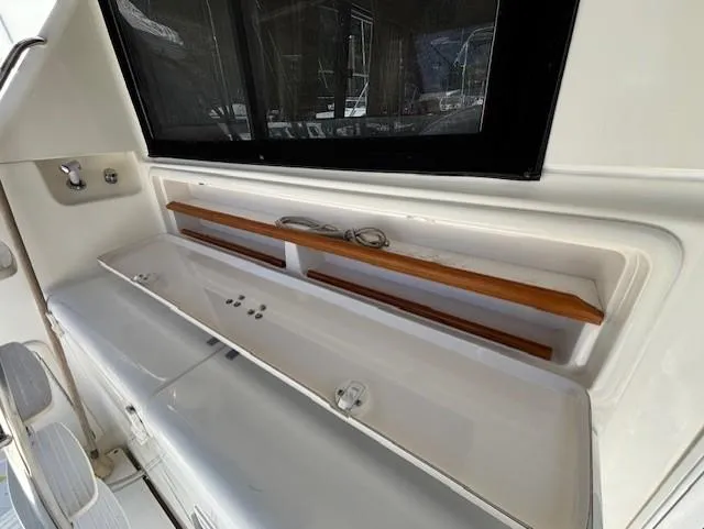 Island Dreamer Yacht Photos Pics 1999 Riviera Convertible boat interior with storage compartments and wooden accents.