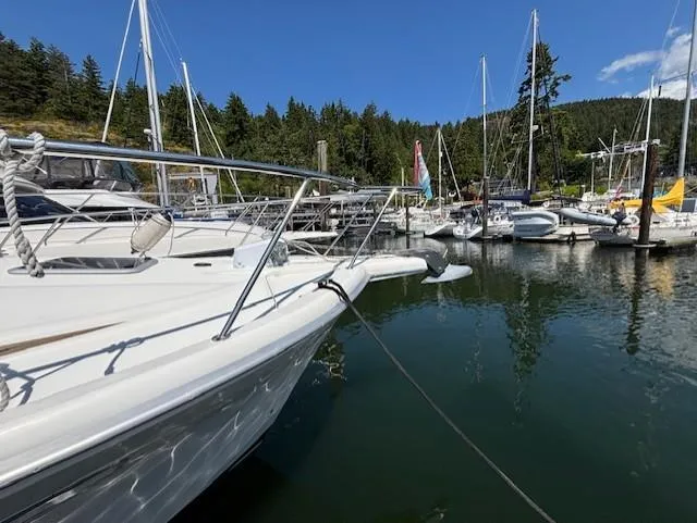 Island Dreamer Yacht Photos Pics 1999 Riviera Convertible yacht docked in a scenic marina with sailboats and trees.