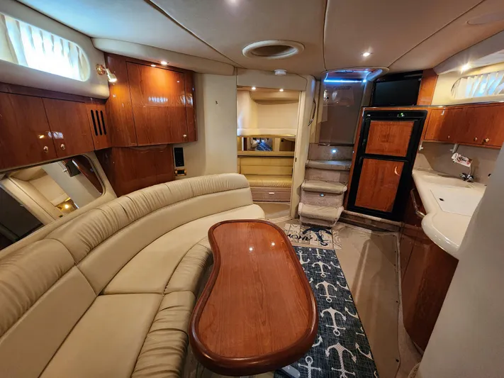 Out Last Night Yacht Photos Pics Luxurious interior of a 2000 Sea Ray 410 Sundancer yacht with elegant wood finishes.