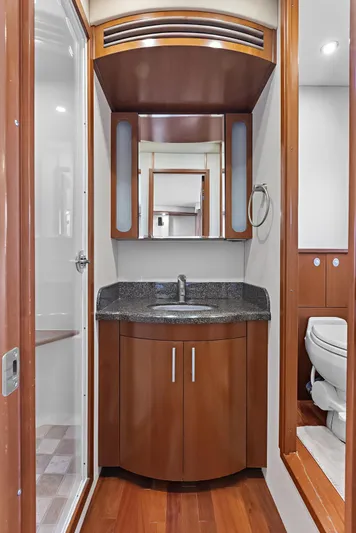  Yacht Photos Pics Luxurious bathroom in 2006 Sea Ray 60 Sundancer yacht with wood cabinetry and modern fixtures.