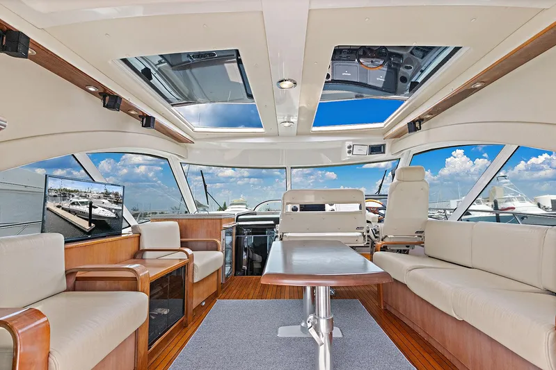  Yacht Photos Pics Luxurious interior of 2006 Sea Ray 60 Sundancer yacht with panoramic windows and elegant seating.