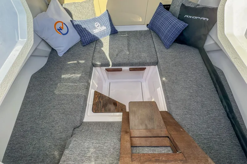  Yacht Photos Pics Interior of 2026 Axopar 29 Sun Top boat with cushioned seating and decorative pillows.